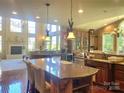 Gourmet kitchen with granite countertops, large island, and high-end appliances at 708 Ridgelake Dr, Weddington, NC 28104