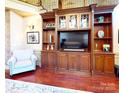 Cozy living room with custom built-in shelving and cabinetry for storage and display at 708 Ridgelake Dr, Weddington, NC 28104