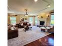 Elegant living room with a fireplace, hardwood floors, and natural light streaming through the windows at 708 Ridgelake Dr, Weddington, NC 28104