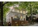 Attractive two-story home featuring a spacious front porch with white railings and a brick foundation at 734 E 10Th St, Charlotte, NC 28202