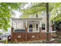 Charming two-story home with a welcoming front porch, brick base and ample natural light at 734 E 10Th St, Charlotte, NC 28202