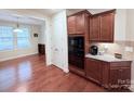 Additional kitchen view with built in microwave, granite counters and wood cabinets at 7581 Short Putt Ct, Charlotte, NC 28215