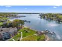 Beautiful aerial view of a waterfront condo with private dock, sandy beach area, and well-maintained green space at 7844 Village Harbor Dr, Cornelius, NC 28031