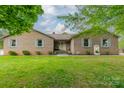 Charming brick home featuring a lush lawn, well-manicured landscaping and stylish shutters at 807 And 809 Sparrow Springs Rd, Kings Mountain, NC 28086