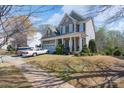 Inviting two-story home featuring a covered front porch and a well-kept lawn at 878 Treasure Ct, Fort Mill, SC 29708
