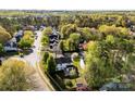 An aerial view of a home with a fenced backyard in a tree-filled neighborhood at 9845 Dauphine Dr, Charlotte, NC 28216