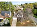 Aerial view of home with large trees in yard on street with other homes nearby at 9845 Dauphine Dr, Charlotte, NC 28216
