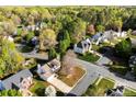 An aerial view showcasing a neighborhood with lush greenery and well-manicured lawns at 9845 Dauphine Dr, Charlotte, NC 28216
