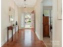 Bright entryway featuring hardwood floors, a decorative mirror, and a view into the adjacent bedroom at 1018 Davant Ln, Charlotte, NC 28209