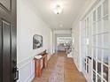 Inviting entryway with wood floors, charming decor, and elegant French doors, creating a warm welcome at 104 Hemlock Cove Ct, Mooresville, NC 28117