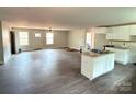 Bright open living room with hardwood floors, white trim, many windows and a ceiling fan at 1127 Mckay Rd, Newton, NC 28658