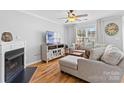 Cozy living room with hardwood floors, fireplace, stylish furnishings, and ample natural light at 11507 Rabbit Ridge Rd, Charlotte, NC 28270