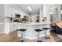 Bright kitchen featuring white cabinets, stainless steel appliances, an island with bar stool seating at 1214 Foxfield Rd, Waxhaw, NC 28173