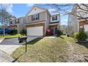 Charming two-story home with a brick and siding exterior, a two-car garage, and a well-manicured lawn at 14328 Evening Flight Ln, Charlotte, NC 28262