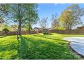 Expansive backyard with lush green grass, mature trees, a storage shed, and a privacy fence at 14827 Smith Rd, Charlotte, NC 28273