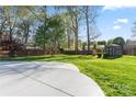 Spacious backyard featuring a large concrete patio area, a storage shed and a wooden fence at 14827 Smith Rd, Charlotte, NC 28273