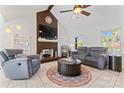 Inviting living room with vaulted ceilings, a brick fireplace, and comfortable seating at 14827 Smith Rd, Charlotte, NC 28273