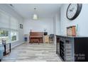 Spacious living room showcasing wood floors, ample seating, and a classic piano at 14911 Barnsbury Dr, Huntersville, NC 28078