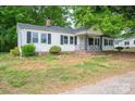 Charming home featuring black shutters, a chimney, and a cozy, covered front porch at 201 Lee Black Rd, Cherryville, NC 28021