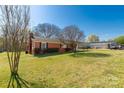 View of the exterior of the home with a spacious lawn, mature trees, and a functional carport at 260 Trexler Ln, Rock Hill, SC 29732