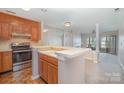 Open kitchen featuring a breakfast bar, and stainless steel appliances overlooking the living area with fireplace at 329 Northwest Dr, Davidson, NC 28036