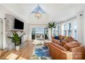 Bright living room with vaulted ceilings, fireplace, and sliding glass doors to a lake view at 336 Northwest Dr, Davidson, NC 28036