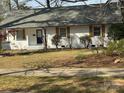 Charming home featuring a freshly painted white brick exterior, new roof, and well-maintained lawn at 3735 Stonehaven Dr, Charlotte, NC 28215