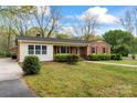 Well-maintained brick home with green lawn, mature trees, and brick accents at 3987 Taxahaw Rd, Lancaster, SC 29720