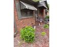 Traditional brick home with awnings and landscaped yard at 4331 Knollcrest Dr, Charlotte, NC 28208