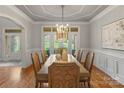 Bright dining room featuring hardwood floors, elegant lighting, and french doors at 8915 Linden Grove Ct, Sherrills Ford, NC 28673