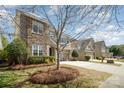 Charming two-story home featuring a stone and siding exterior, two-car garage, and well-maintained landscaping at 9422 Ridgeforest Dr, Charlotte, NC 28277