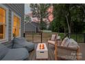 Cozy outdoor deck with a fire pit and comfortable seating, ideal for entertaining guests and enjoying the backyard at 9849 Rich Hatchet Rd, Huntersville, NC 28078
