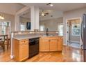 Functional kitchen featuring wood cabinets, laminate countertops and hardwood floors with backyard view at 1009 Summer Creste Dr, Indian Trail, NC 28079