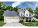 Charming two-story home with a well-maintained lawn and a two car garage at 10125 Loch Lomond Dr, Charlotte, NC 28278