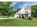Charming two-story home with a well-maintained lawn and a two car garage on a spacious lot at 10125 Loch Lomond Dr, Charlotte, NC 28278