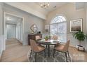 Elegant dining room with a round table, arched window, stylish decor, and a cozy ambiance at 111 Sterling Dr, York, SC 29745