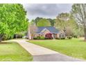 Expansive property featuring a winding driveway, lush green lawn, and beautifully landscaped surroundings at 111 Sterling Dr, York, SC 29745