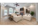 Bright living room with brick fireplace, large windows, hardwood floors and elegant furnishings at 111 Sterling Dr, York, SC 29745