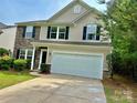 Charming two-story home featuring a two-car garage, stone accents, and a well-maintained front yard at 12815 Towering Pine Dr, Charlotte, NC 28269