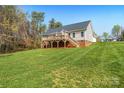 Expansive backyard featuring a large wooden deck, perfect for outdoor entertaining at 16 Shadow Dr, Taylorsville, NC 28681