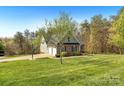 Charming home with a basketball hoop, well-maintained lawn, and an attached two car garage at 16 Shadow Dr, Taylorsville, NC 28681