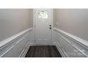 Elegant entryway featuring detailed trim work and modern dark floors at 1721 Balfour Ln, Charlotte, NC 28216