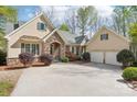 Beautiful home with stone accents and a three-car garage, showcasing curb appeal at 176 Sunset Bay Dr, Troutman, NC 28166
