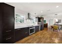 Modern kitchen with stainless steel appliances, dark wood cabinetry and a bright adjacent dining area at 2314 Wolfe St, Charlotte, NC 28205