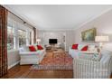 Bright living room featuring hardwood floors, comfortable seating, and large windows offering ample natural light at 3524 Johnny Cake Ln, Charlotte, NC 28226
