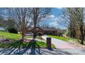 Charming brick home with a manicured lawn and long driveway, offering curb appeal at 3730 Club House Ne Dr, Conover, NC 28613