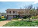Well-maintained two-story home featuring a brick foundation, attached garage and manicured lawn at 409 Cardinal Dr, Newton, NC 28658