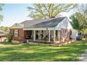 Charming brick home with inviting front porch and well-manicured lawn, landscaped for curb appeal at 412 W D Ave, Salisbury, NC 28144