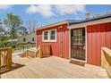 Newly built deck featuring a dark door that provides backyard access to the beautiful red home at 50 Sixth St, York, SC 29745