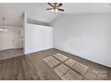 Empty Living Room featuring light wood flooring, a vaulted ceiling and neutral walls ready to be customized at 5407 Windy Valley Dr, Charlotte, NC 28208